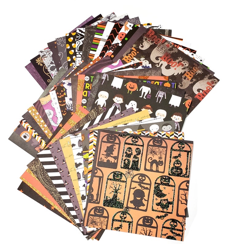 May include: A collection of Halloween-themed scrapbook paper sheets. The sheets display various patterns, including ghosts, pumpkins, and bats, in orange, black, and white. Some sheets have the word "Boo!" printed on them. The paper is ideal for crafting.