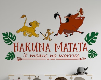 May include: A white wall with a green, brown, and yellow wall decal featuring the characters Simba, Pumbaa, and Timon from the Disney movie The Lion King. The decal reads "Hakuna Matata it means no worries".