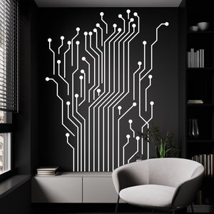Könnte beinhalten: Ein weißes Leiterplatten-Design an einer schwarzen Wand in einem modernen Wohnzimmer. Das Design besteht aus einer Reihe von Linien und Kreisen, die ein geometrisches Muster bilden. Ein weißer Sessel steht vor der Wand, und im Hintergrund ist ein Bücherregal zu sehen.