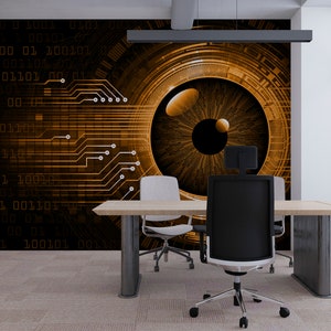 May include: A modern office interior with a large wall mural featuring a stylized eye with a circuit board pattern. The eye is brown with a black pupil and is surrounded by a gold-colored ring. The wall mural is behind a large wooden desk with two chairs.
