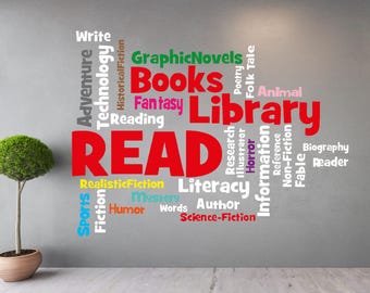 May include: A wall decal with the word "READ" in large red letters surrounded by smaller words related to books and reading, including "Library", "Books", "Adventure", "Technology", "Fantasy", "Mystery", "Science Fiction", "Biography", "Sports", "Humour", "Author", "Illustrator", "Research", "Information", "Reference", "Fable", "Non-Fiction", "Folk Tale", "Poetry", "Realistic Fiction", "Graphic Novels", "Reading", and "Write".