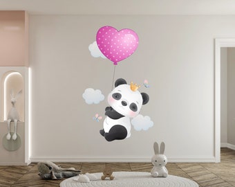May include: A black and white panda bear wearing a gold crown holds onto a pink heart-shaped balloon with white polka dots. The panda is surrounded by white clouds and butterflies.