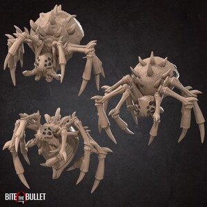 May include: Three detailed, 3D printed, beige-colored spider figurines with spiky bodies and long, spindly legs. The spiders are posed in different positions, with one facing forward, one facing the side, and one facing the viewer.