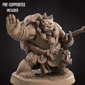 May include: A detailed, pre-supported 3D printed miniature of a turtle-like creature with a staff and a backpack. The miniature is in a fighting pose with one hand raised and the other holding the staff. The miniature is painted in a light brown color.