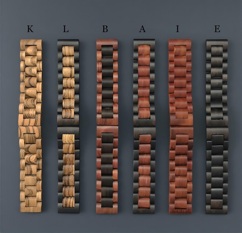 May include: Six wooden watch bands in various colors and wood grains. The bands are arranged vertically against a dark gray background. The bands include light and dark wood tones, with black metal hardware. Each band is labeled with a letter.