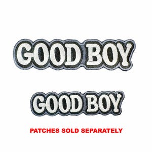 May include: Two embroidered patches featuring the text GOOD BOY in white block letters with a thick black outline and a grey border. The patches have a scalloped edge following the shape of the letters. The text PATCHES SOLD SEPARATELY is below.