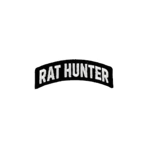 May include: A black, curved patch with white embroidered text reading "RAT HUNTER". The patch features a simple, clean design, with the text arched across the centre.