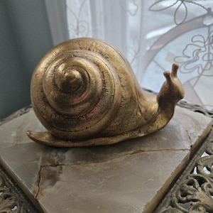 May include: A rustic wooden sign with the text "Welcome to our home" in white lettering. The sign has a distressed finish and a simple, inviting design, suitable for a front porch or entryway.