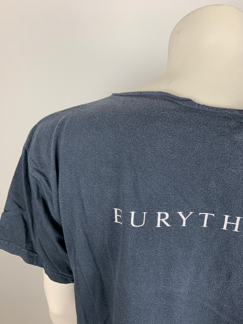 May include: A dark grey t-shirt with the word "EURYTHM" printed in white on the back.