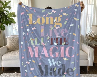 May include: A blue fleece blanket with confetti printed on it. The blanket has the text "Long Live All The Magic We Made" printed on it in a colourful font.