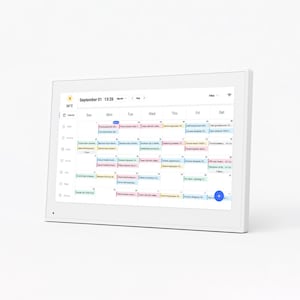 May include: A white digital calendar displaying a monthly schedule for September. The screen shows appointments and events in various colors. The time is 13:26, and the temperature is 26°C. The device has a white frame.