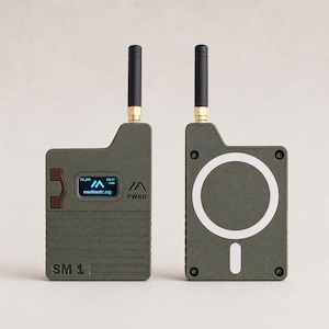 May include: Two olive-green electronic devices with black antennas. One device displays a screen with text and a logo, the other has a white circle and a line. The text "meshastic.org" and "SM 1" are visible.