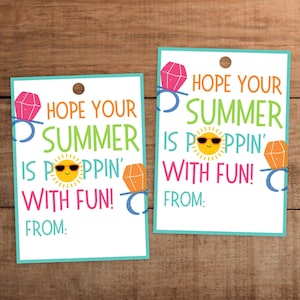 May include: Two rectangular gift tags with a turquoise border and a hole at the top. The tags read "HOPE YOUR SUMMER IS POPPIN' WITH FUN!" with a sun graphic and diamond ring illustrations. The bottom of the tags read "FROM:"