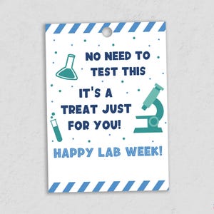May include: A white gift tag with blue and teal graphics and text. The tag reads "NO NEED TO TEST THIS, IT'S A TREAT JUST FOR YOU! HAPPY LAB WEEK!" with illustrations of lab equipment.