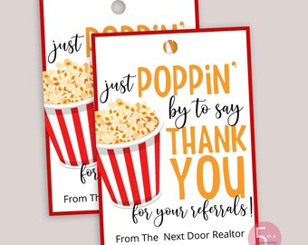 May include: Two rectangular white gift tags with red borders, each featuring a graphic of a red and white striped popcorn bucket. The text reads: just POPPIN' by to say THANK YOU for your referrals! From The Next Door Realtor.