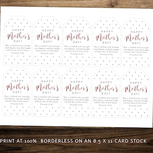 May include: Printable gift tags with a black and white polka dot pattern. The tags feature the text "Happy Mother's Day!" in red cursive lettering and a Bible verse about strength and dignity. The tags are designed to be printed at 100% on 8.5 x 11 card stock.
