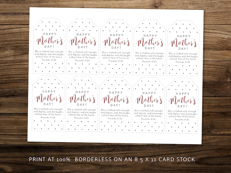 May include: Printable gift tags with a black and white polka dot pattern. The tags feature the text "Happy Mother's Day!" in red cursive lettering and a Bible verse about strength and dignity. The tags are designed to be printed at 100% on 8.5 x 11 card stock.