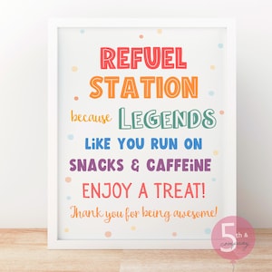 May include: White framed print with colorful text that reads "REFUEL STATION because LEGENDS LIKE YOU RUN ON SNACKS & CAFFEINE ENJOY A TREAT! Thank you for being awesome!" with pastel polka dots.