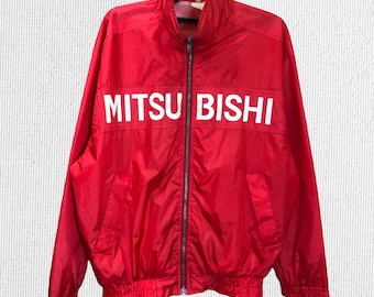 May include: A red windbreaker jacket with a white "MITSUBISHI" logo on the front.
