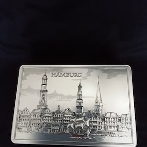Silver Hamburg Skyline embossed tin with sailing ship and 3 cathedrals. Removable lid. Empty, usable, collectible. Stolwerck. see photos