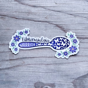 May include: Purple and white sticker with a spoon design and the text "Fibromyalgia Warrior" surrounded by purple flowers and butterflies.