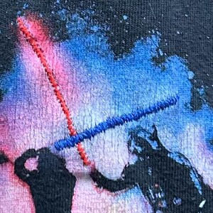 Light Sabers are highlighted with red and blue thread