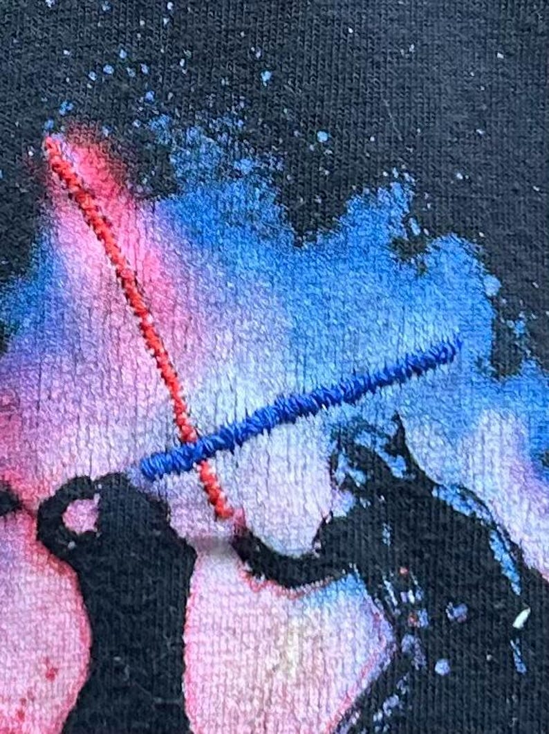 Light Sabers are highlighted with red and blue thread