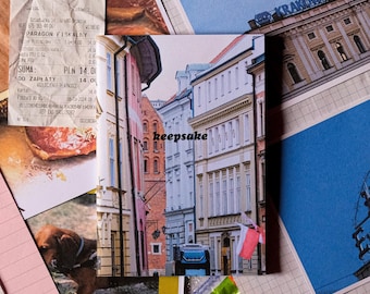 May include: A close-up of a small, colorful booklet with the word "keepsake" printed on the front cover. The booklet is lying on a table with other objects, including a receipt, a postcard, and candy wrappers.