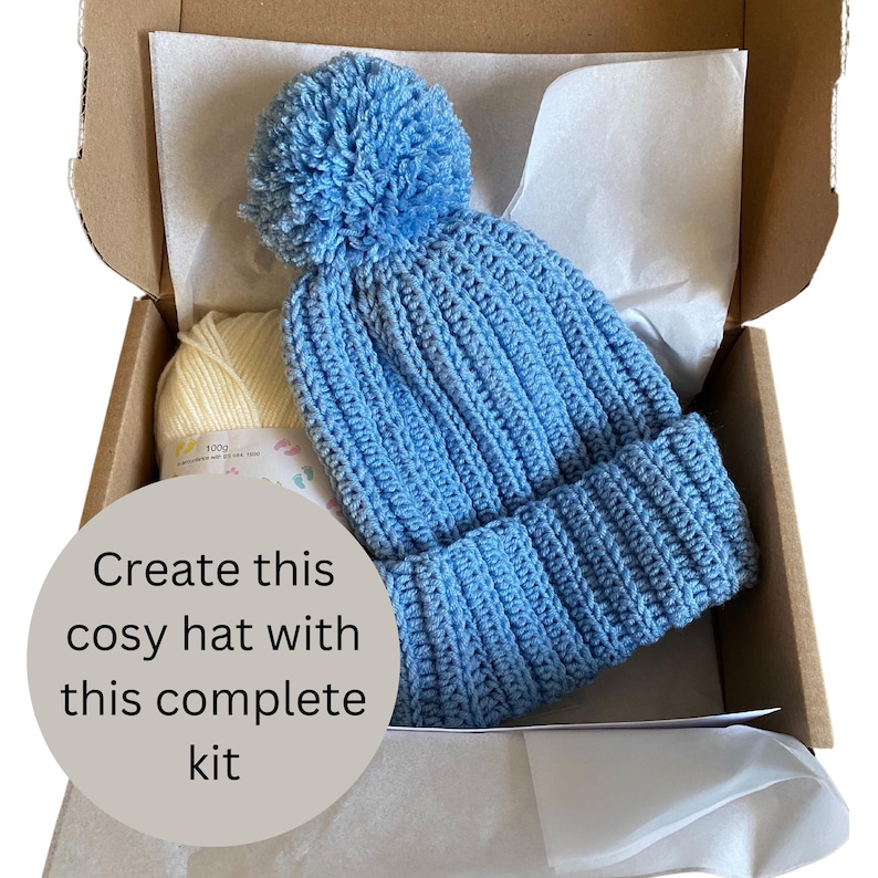 A complete crochet kit, including yarn, hook, scissors, tape measure, pompom maker and PDF print out of the pattern for a hat with pompom.