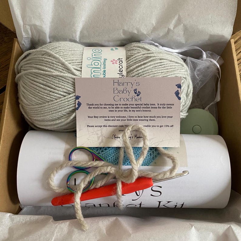 A complete crochet kit, including yarn, hook, scissors, tape measure and PDF print out of the pattern for a baby sized blanket.