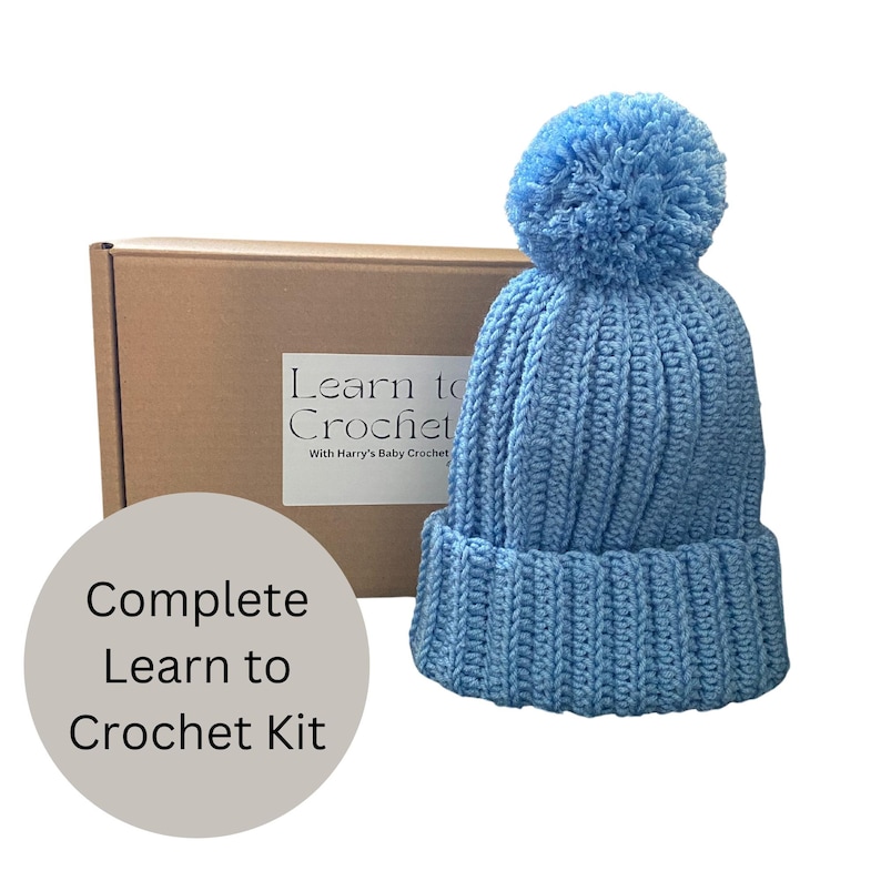 A complete crochet kit, including yarn, hook, scissors, tape measure, pompom maker and PDF print out of the pattern for a hat with pompom.
