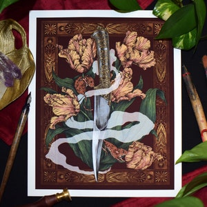May include: Art print featuring a detailed illustration of a dagger overlaid on a floral arrangement of tulips and foliage. The artwork is set against a burgundy background with gold decorative borders. The dagger has an ornate handle.
