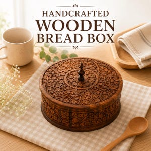 May include: A round, dark brown wooden bread box featuring intricate floral carvings across the lid and sides, topped with a small central finial handle. The text HANDCRAFTED WOODEN BREAD BOX is displayed above the container in dark brown lettering.