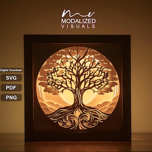 Puede incluir: Un marco cuadrado tipo caja de sombra que contiene un recorte de papel en capas de un árbol con ramas y raíces intrincadas, iluminado desde atrás con una luz dorada cálida. El texto "mv MODALIZED VISUALS" aparece en la parte superior, con las etiquetas "Digital Download", "SVG", "PDF" y "PNG" a la izquierda.