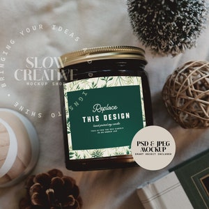 May include: A black glass candle jar with a gold lid and a green label that says "Replace This Design". The label has a floral design and the text "Hand poured soy candle,  This is for the 8 oz candle in an amber jar."