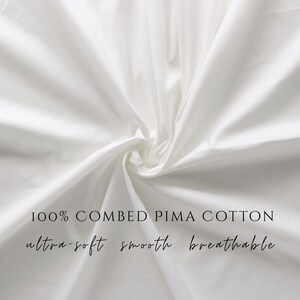 May include: A close-up of white fabric with soft folds. The text on the image reads "100% Combed Pima Cotton, ultra-soft, smooth, breathable."