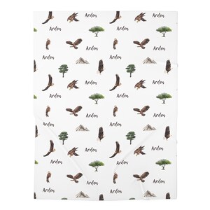 May include: White background with a repeating pattern of brown eagles, green trees, and brown mountains. The word "Arden" is repeated throughout the pattern.