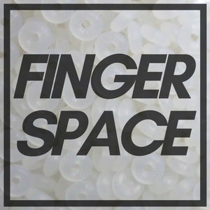 May include: A close-up of a white background with the words "FINGER SPACE" in black text.