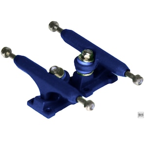 May include: A pair of navy blue skateboard trucks with silver fixings. The trucks are designed for mounting on a skateboard deck. The baseplates have mounting holes for attachment. The image is on a white background.