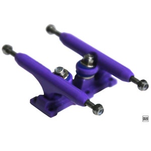 May include: Purple fingerboard trucks with silver axles. The trucks are made of plastic and have a smooth finish.