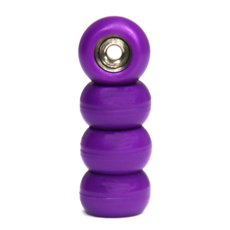 May include: Four purple fingerboard wheels stacked on top of each other. The wheels have a silver bearing in the center.