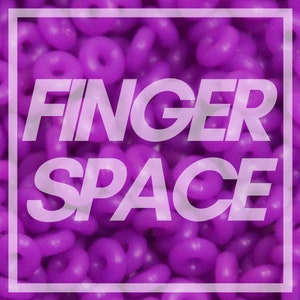 May include: A close-up image of a purple background with the text "FINGER SPACE" in white letters.