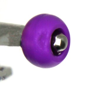 May include: A close-up of a purple plastic ball with a silver metal ball bearing inside. The ball is smooth and has a slight shine.