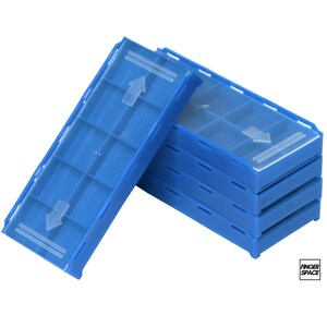 May include: Stack of blue plastic storage containers with clear lids. Each container has a grid of small compartments and a white arrow indicating direction. The containers are stacked at an angle.