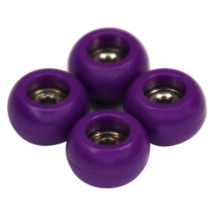 May include: Four purple fingerboard wheels with silver bearings.