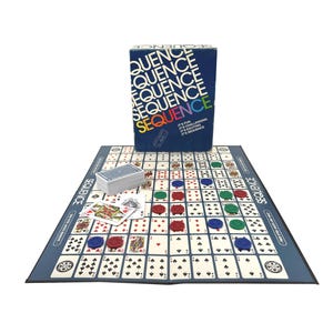 May include: A Sequence board game set. The game includes a blue game board, a deck of cards, and colored game chips. The box is blue with the word "SEQUENCE" in white and rainbow colors. The game board has a grid of playing cards.