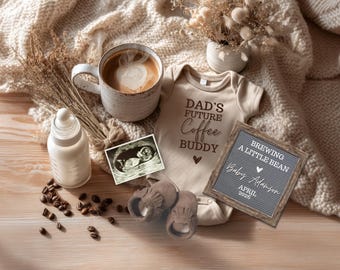 May include: A neutral-toned baby announcement scene with a coffee mug, baby bottle, ultrasound image, and a onesie that reads "Dad's Future Coffee Buddy." A letter board announces "Brewing a Little Bean" and the baby's name and due date.
