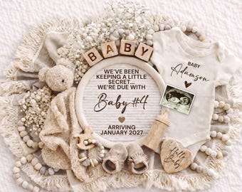 May include: A neutral-toned baby announcement with a teddy bear, baby clothes, and a sonogram. The announcement includes the text "Baby #4" and "Arriving January 2027". A wooden block sign spells out "BABY".