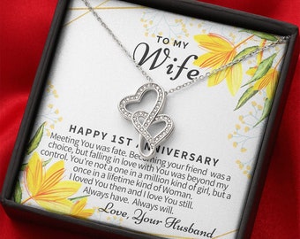 May include: A silver necklace with two intertwined heart charms, presented in a black gift box with a message that reads "To My Wife Happy 1st Anniversary Meeting You was fate. Becoming your friend was a choice, but falling in love with You was beyond my control. You're not a one in a million kind of girl, but a once in a lifetime kind of Woman. I loved You then and I love You still. Always have. Always will. Love, Your Husband"