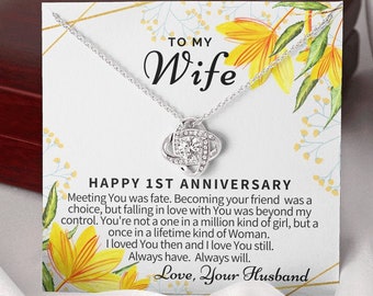 May include: A silver necklace with a knot pendant and a card that says "To My Wife Happy 1st Anniversary" with a floral design. The card includes a message about love and fate.